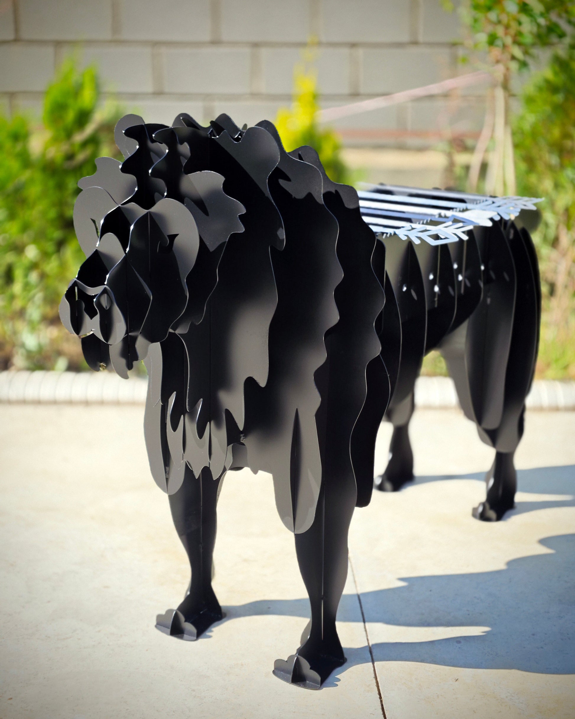 Black metal lion Grill on a concrete surface with a blurred background