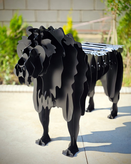 Black metal lion Grill on a concrete surface with a blurred background